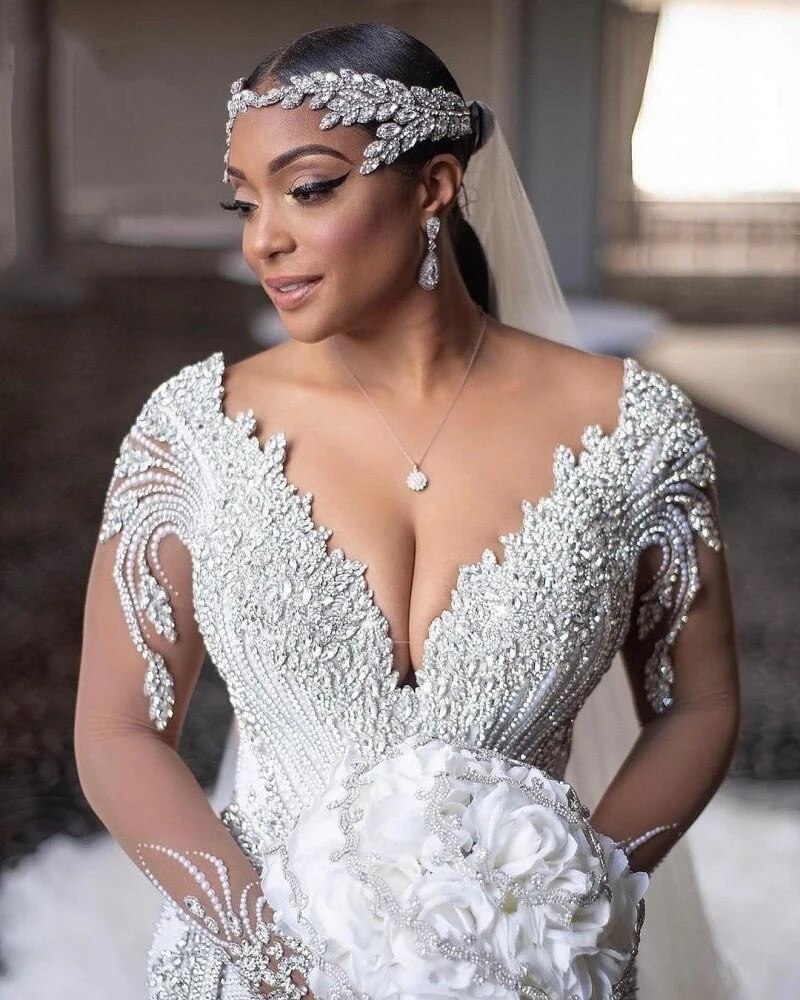 https://dariusfashions.com/cdn/shop/products/2022-Luxury-Beaded-Mermaid-Wedding-Dresses-Princess-Crystal-Pearls-Beading-Corset-V-Neck-Organza-Ruffles-Cathedral.jpg_Q90.jpg__2_800x.jpg?v=1675291706