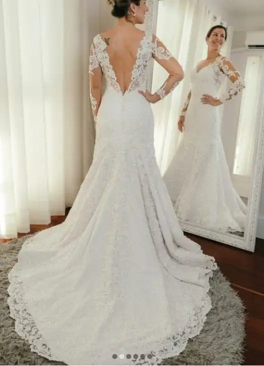 Traditional long sleeve lace wedding gown with V-back