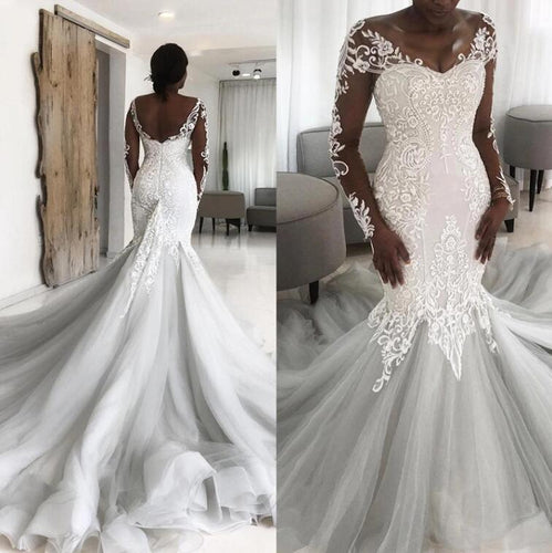 C511121 - Vestido de novia entallado y con vuelo de manga larga transparente